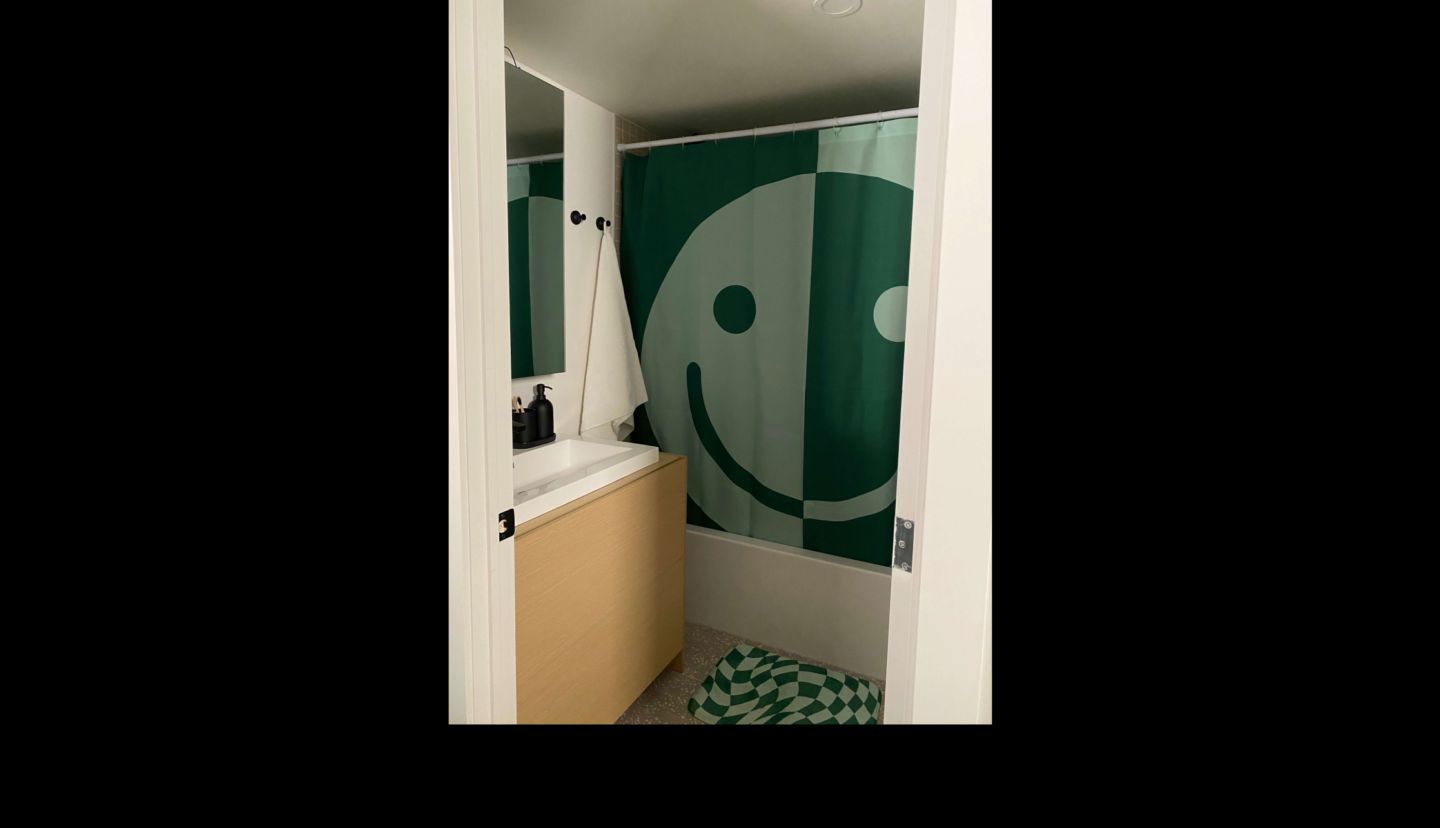 bathroom with smiley face curtain