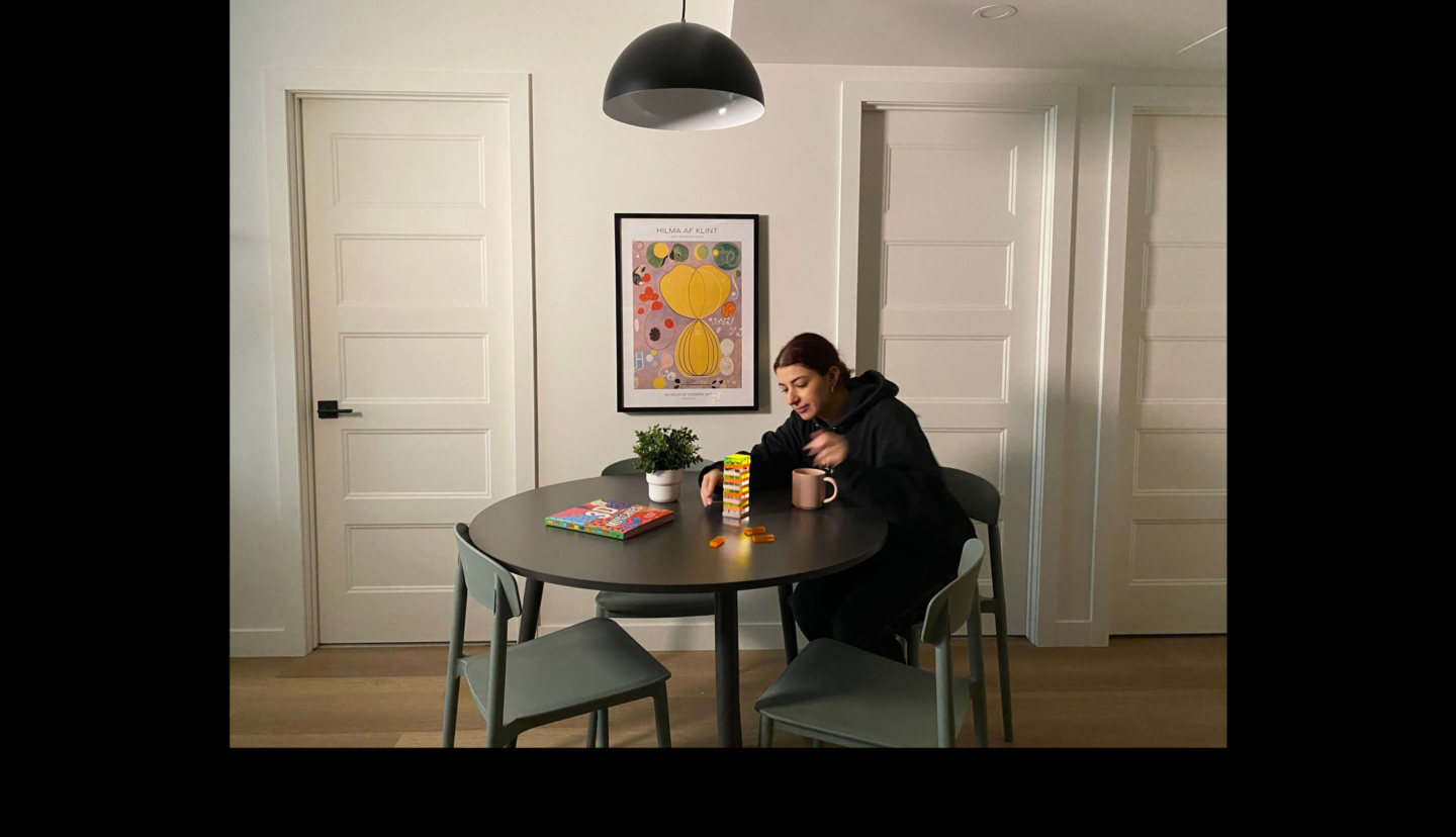 student playing jenga at dining room table