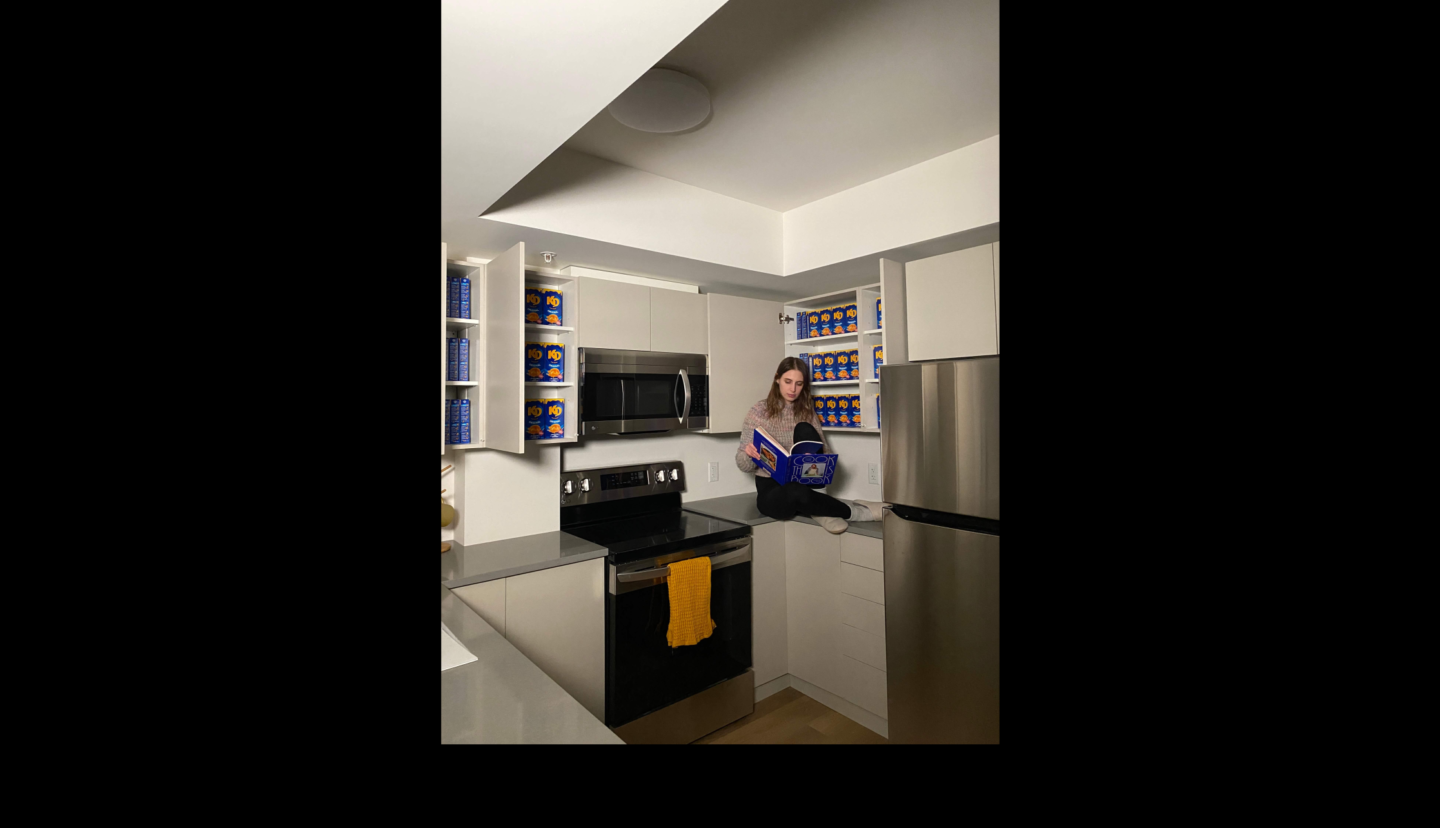 student reading cookbook on kitchen counter